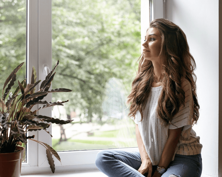 Woman resting by a window
